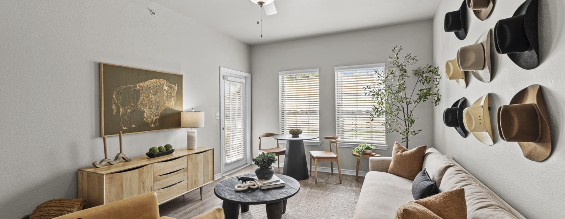 a living room with a fan and couches