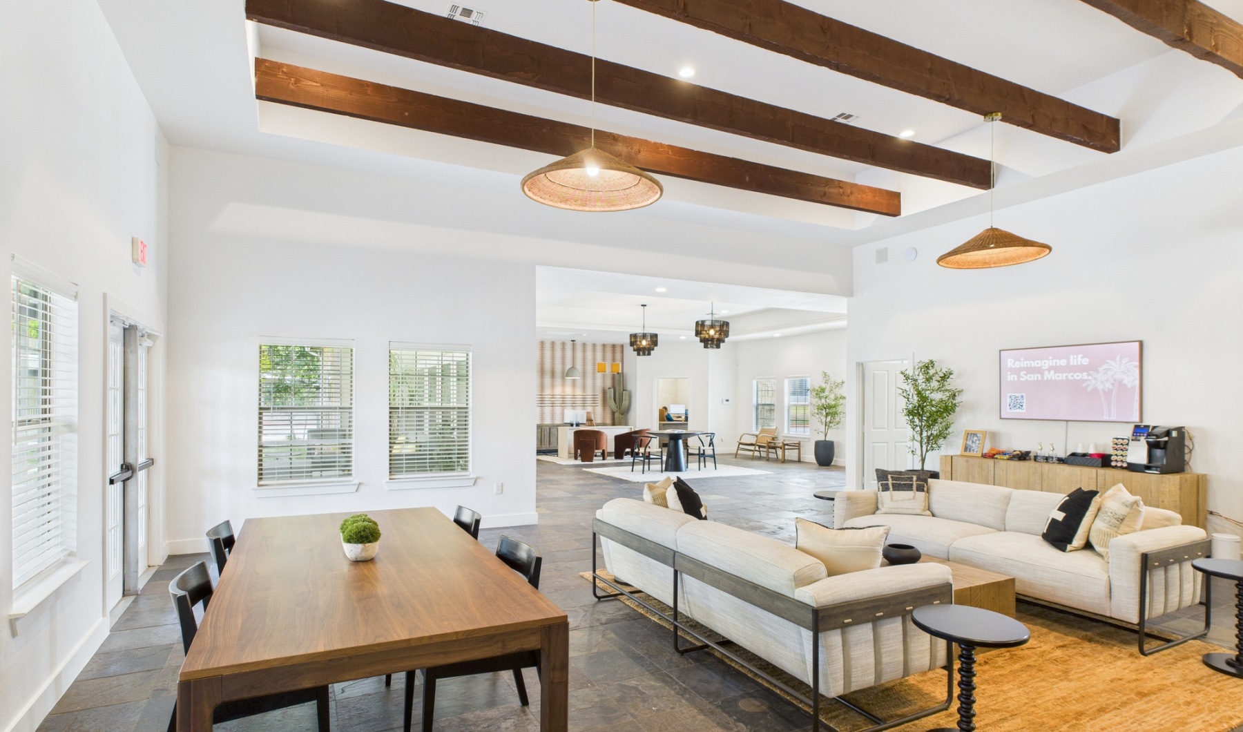 Clubhouse with furniture and high ceilings with wood beams