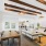 Clubhouse with furniture and high ceilings with wood beams