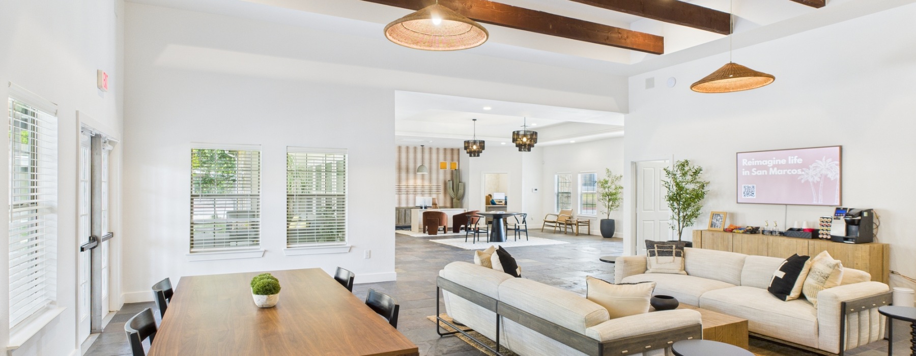 Clubhouse with furniture and high ceilings with wood beams