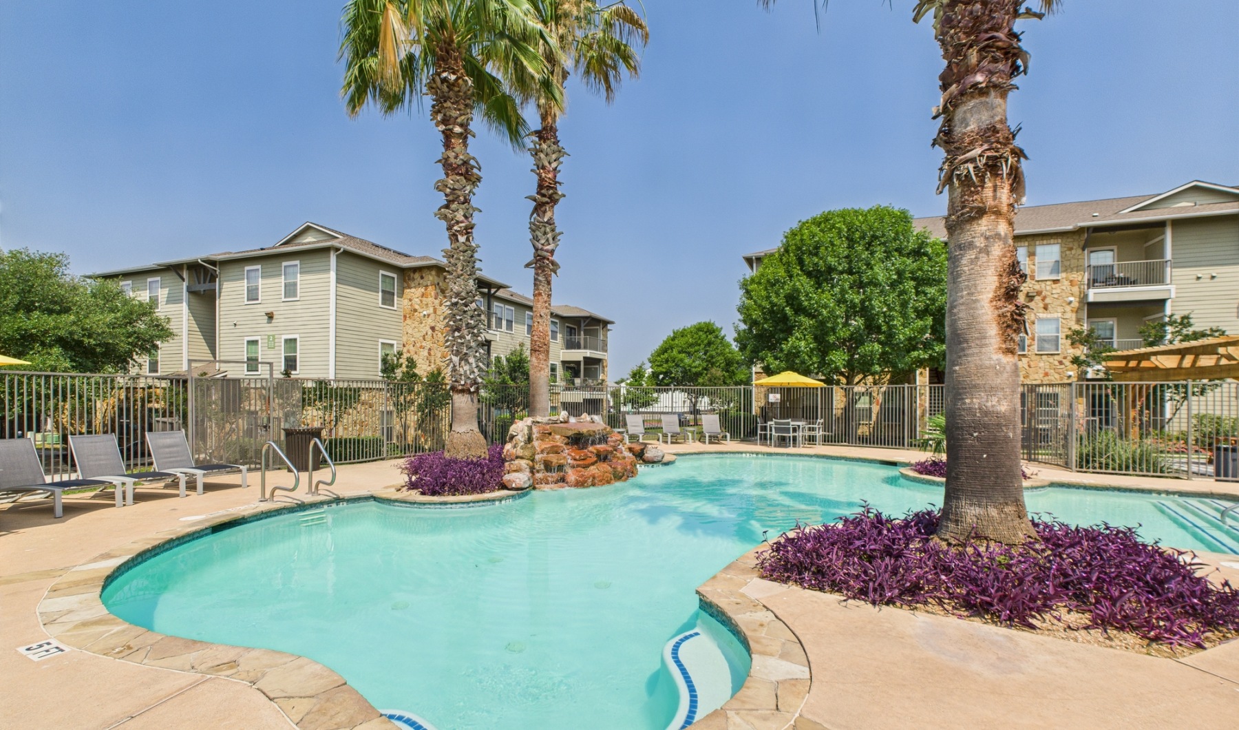 Dive into luxury living near Rio Vista Park Swimming pool surrounded by palm trees