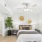 Styled bedroom with large faux tree