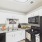 Styled kitchen with white cabinets and black appliances