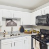 Styled kitchen with white cabinets and black appliances