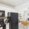 Kitchen with white cabinets and black appliances