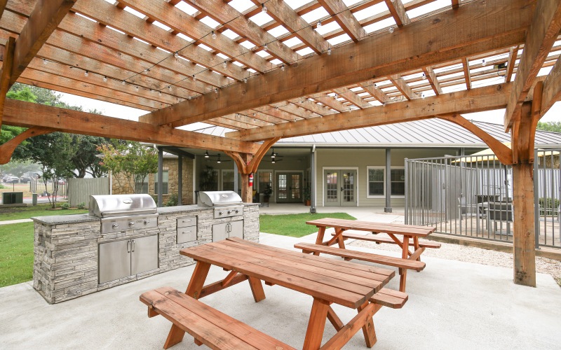 Grilling pergola with grills and tables