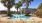 Apartment pool surrounded by palm trees