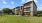 a row of apartments with a lawn in front of it