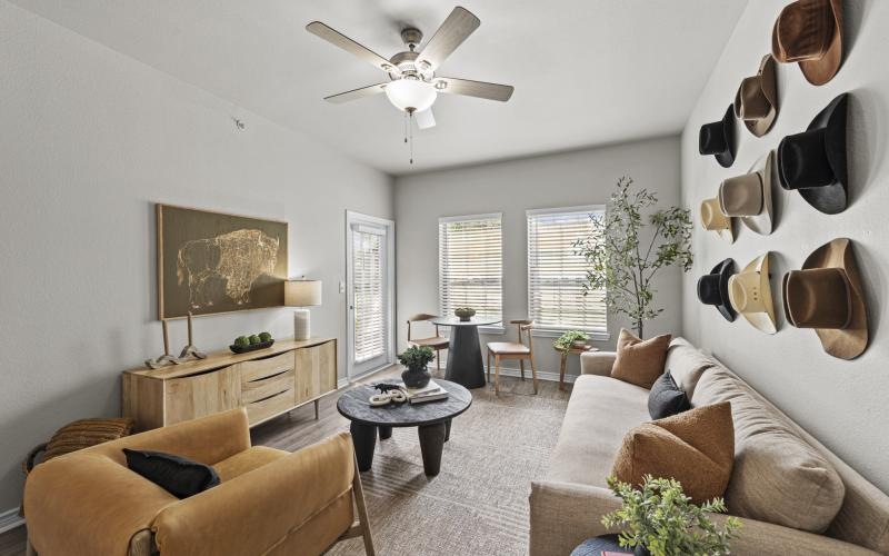 a living room with a fan and couches