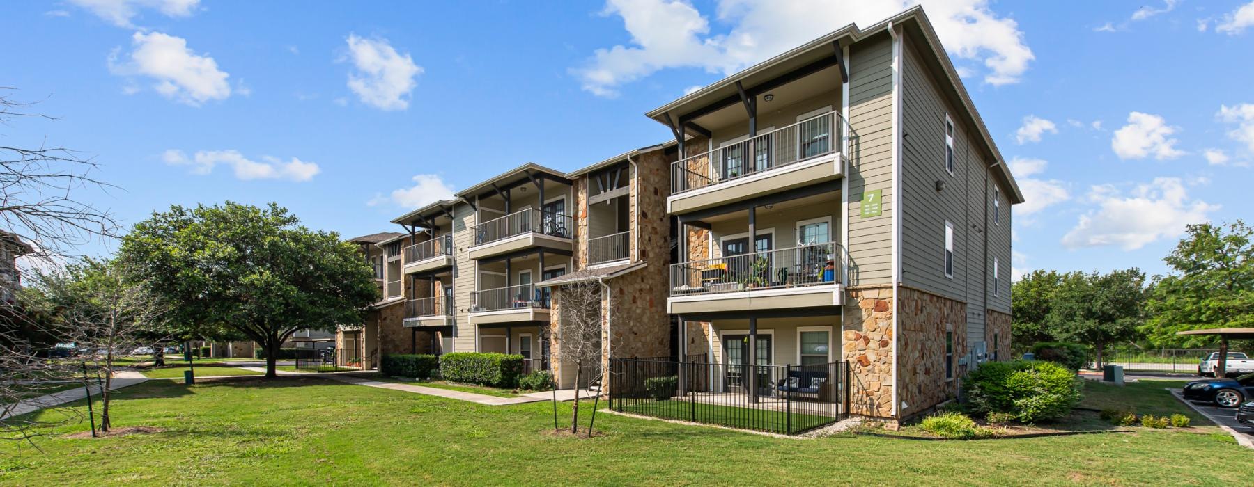 a row of apartments with a lawn in front of it