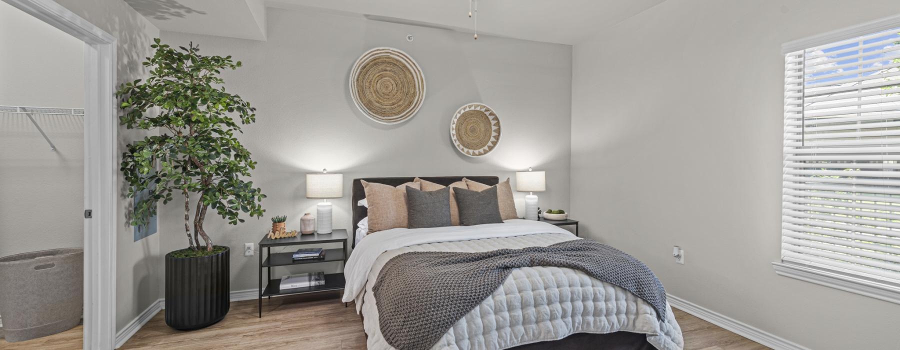 a bedroom with a large bed and a fan